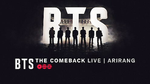 Silhouettes of seven people standing in front of large lit-up BTS letters with "BTS THE COMEBACK LIVE | ARIRANG" text at the bottom, dark concert stage background.