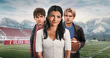 Ashby Gentry as Alex Walter, Nikki Rodriguez as Jackie Howard, and Noah LaLonde as Cole Walter stand in front of football field with mountains in the background in Season 1 of 'My Life With the Walter Boys'