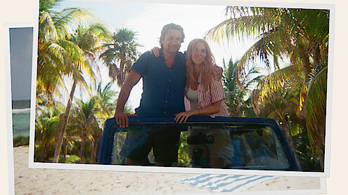 Mel and Jack standing arm in arm in a Jeep while in Tulum on their honeymoon 