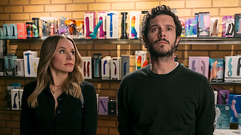 Kristen Bell as Joanne looks up at Adam Brody as Noah in a sex shop in Season 1 of 'Nobody Wants This'