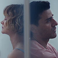 A man and a woman facing away from each other