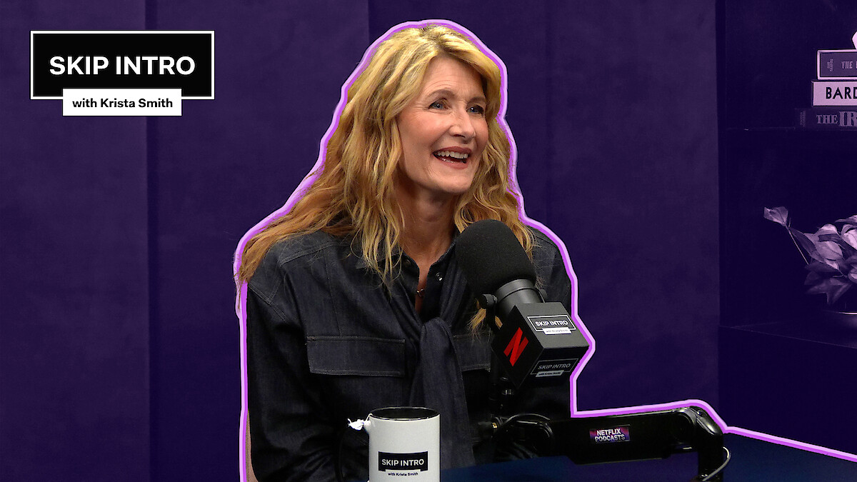 Laura Dern sits smiling in front of a microphone during a podcast recording for "Skip Intro with Krista Smith." The background is purple, and the podcast logo appears in the top left corner.