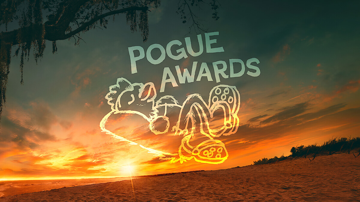 Cartoon character reclining in Crocs with text "POGUE AWARDS" in the sky, set against a vibrant beach sunset with trees and dramatic clouds in the background.