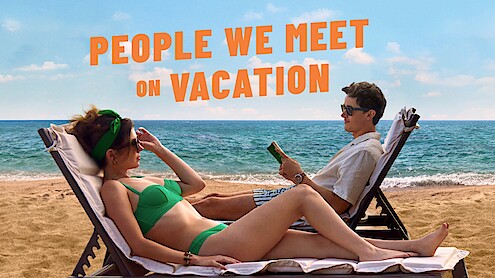 Two people on sun loungers on the beach