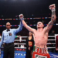 The referee raises the arm of Callum Walsh after he won by unanimous decision against Fernando Vargas Jr. in their light middleweight bout during Netflix's Canelo v Crawford Fight Night at Allegiant Stadium