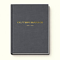 A hardcover book with a dark gray cloth cover titled "OUTER BANKS 2020–2029" in gold lettering, set against a plain cream-colored background. The book appears to be closed and viewed from above.