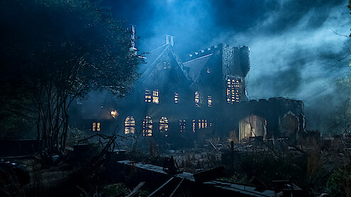 Old, abandoned mansion at night surrounded by overgrown vegetation, eerie mist, and dramatic lighting creating a spooky, haunted atmosphere. Broken windows and ruined walls add to the mysterious, unsettling mood of the scene.