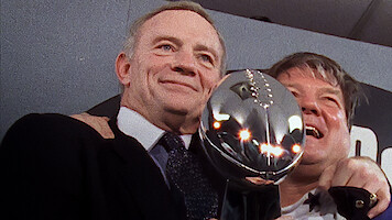 Jerry Jones holding the Vince Lombardi Trophy