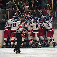 A ice hockey team celebrating in the rink