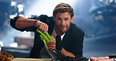 Chris Hemsworth cracks some celery in a still from an 'Extraction 2' promo video.