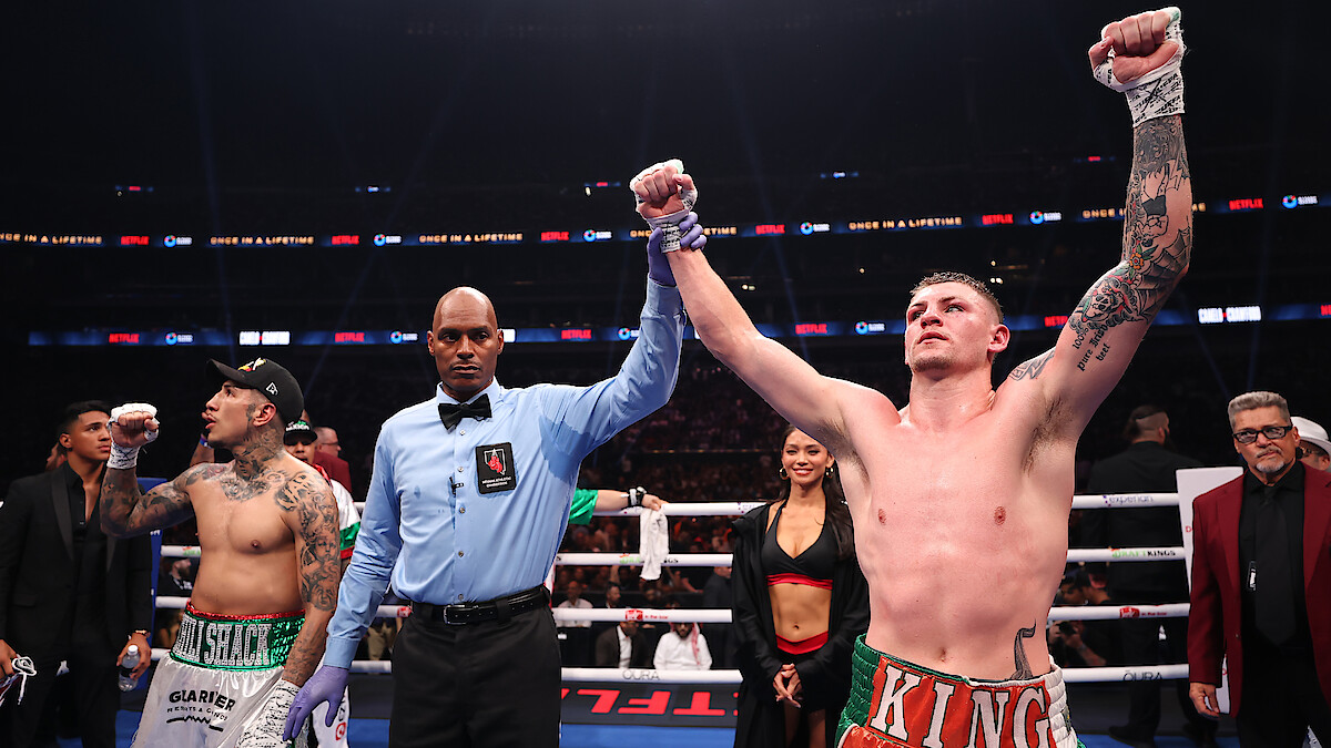 The referee raises the arm of Callum Walsh after he won by unanimous decision against Fernando Vargas Jr. in their light middleweight bout during Netflix's Canelo v Crawford Fight Night at Allegiant Stadium