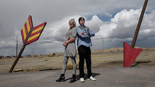 Harper Steele and Will Ferrell stand back-to-back.