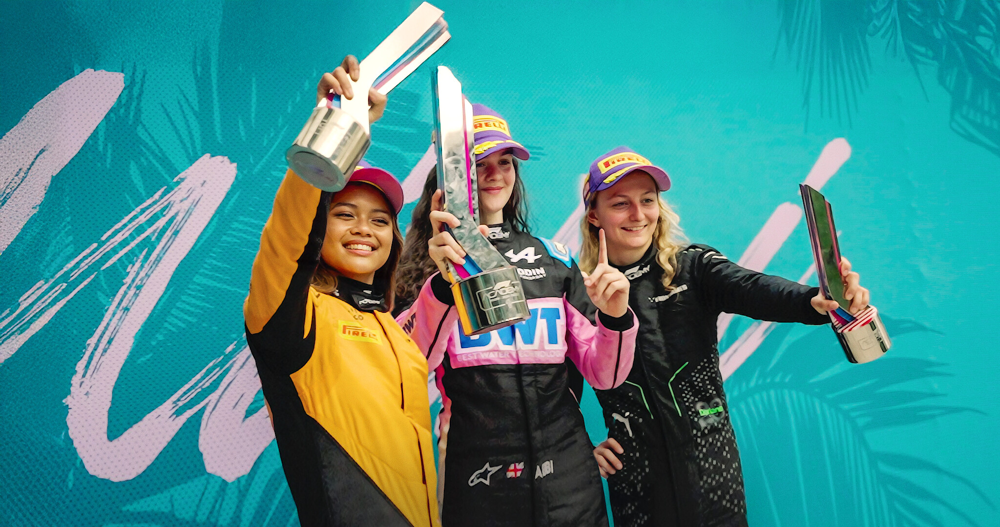 F1: The Academy - Drivers from F1 holding up trophies on a blue/teal background