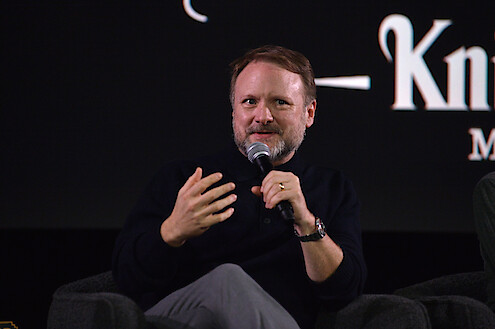 Rian Johnson sits on stage during the panel from The Lineup