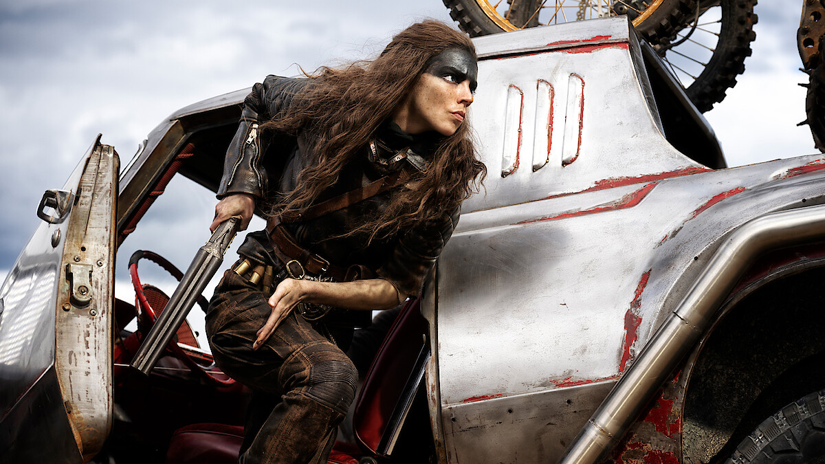 Anya Taylor-Joy as Furiosa getting out of car with shotgun