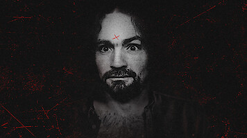 A man with curly hair and a beard stares intensely at the camera, set against a dark, gritty background. He has a red X marked on his forehead and visible chest hair, wearing an open shirt. The overall mood is eerie and dramatic.