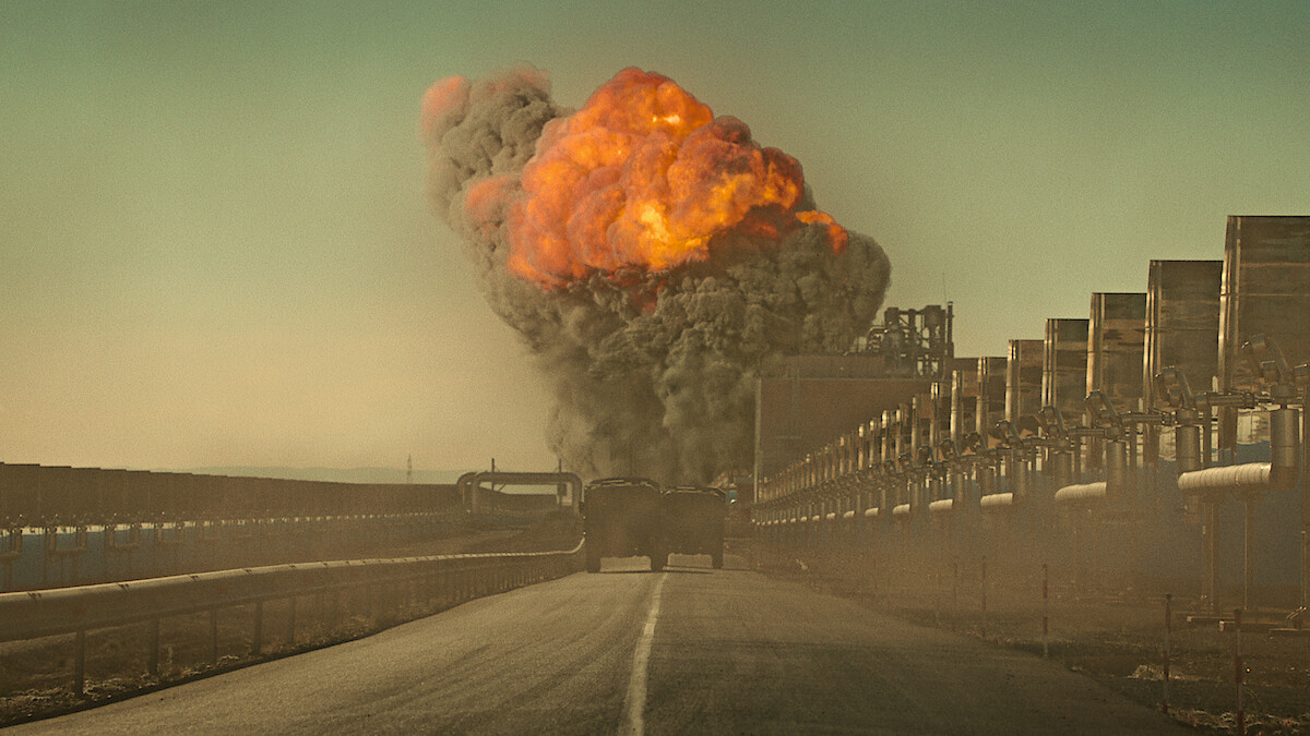 Trucks drive towards a large explosion in 'The Wages of Fear'