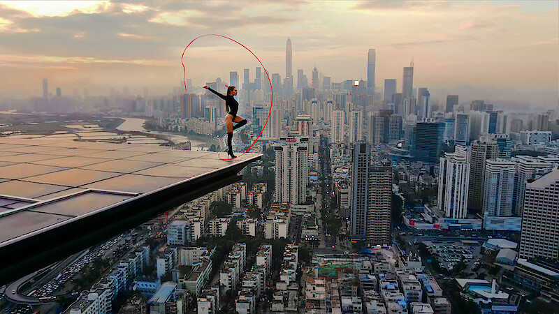 Angela Nikolau performing on top of a building.