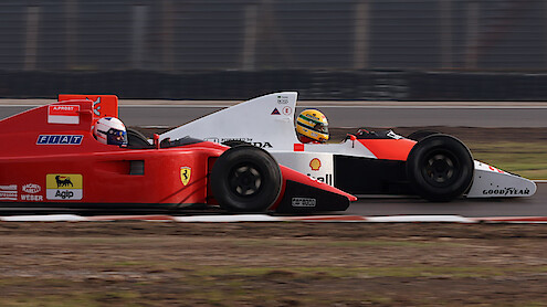 A warehouse with three F1 car models 