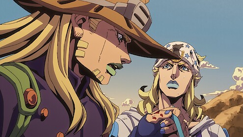 Two animated characters with long blond hair, distinctive hats, and outfits stand outdoors in a desert landscape, engaged in conversation under a clear sky with mountains in the background.