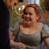 Nicola Coughlan as Penelope Featherington laughs at a ball in Season 3 of 'Bridgerton.'