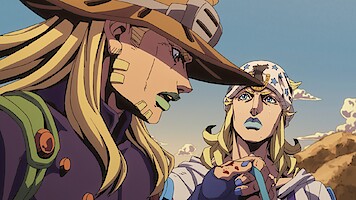Two animated characters with long blond hair, distinctive hats, and outfits stand outdoors in a desert landscape, engaged in conversation under a clear sky with mountains in the background.