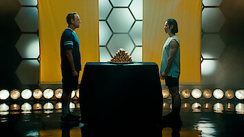 Chestnut and Kobayashi face off with a pile of hot dogs between them.