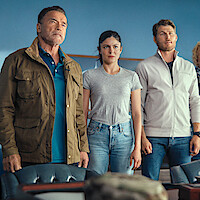 Arnold Schwarzenegger as Luke Brunner, Monica Barbaro as Emma Brunner, and Travis Van Winkle as Aldon Reece in 'FUBAR' Season 2.