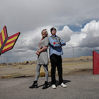 Harper Steele and Will Ferrell stand back-to-back.