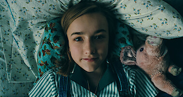 Little girl awake in bed