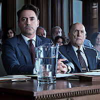 Robert Downey Jr., Robert Duvall, and Dax Shepherd sitting in a courtroom.