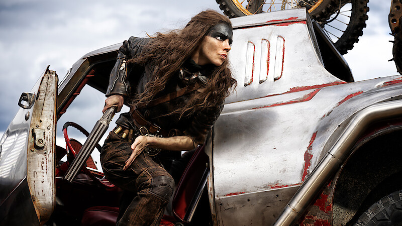 Anya Taylor-Joy as Furiosa getting out of car with shotgun