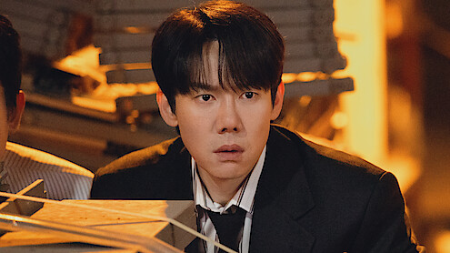 Yoo Yeon-seok as Shin I-rang looking over cases in 'Phantom Lawyer.'
