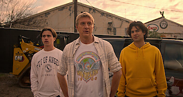Tanner Buchanan as Robby, William Zabka as Johnny, and Xolo Maridueña as Miguel stare with puzzled expressions in Season 6 of 'Cobra Kai'