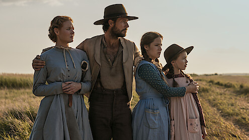 A family looks off into the distance together.