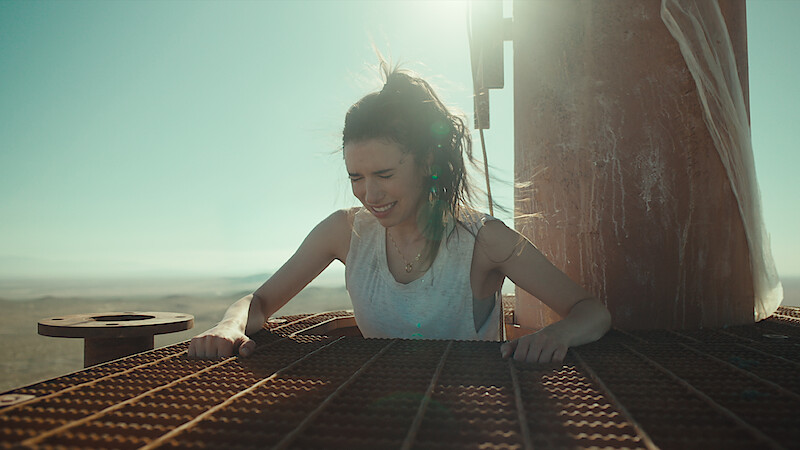 Grace Caroline Currey as Becky Connor hauling herself up on the radio tower platform in 'Fall.'