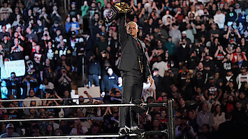 Cody Rhodes raising his belt in the ring.