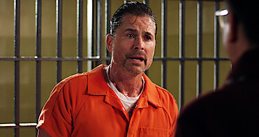 Robe Lowe as Ellis Dragon stands in an orange jumpsuit in Season 2 of 'Unstable'