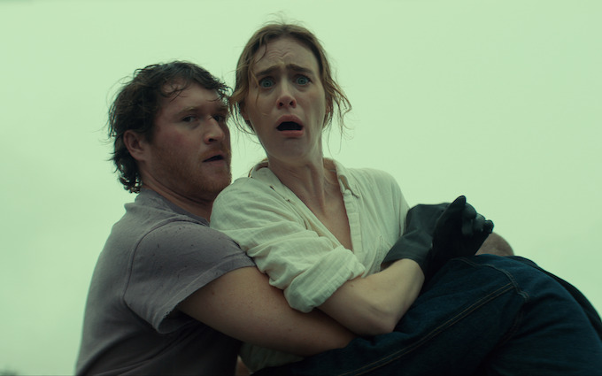 A frightening moment in Netflix Below Two characters react with alarm in a scene from Netflix Below