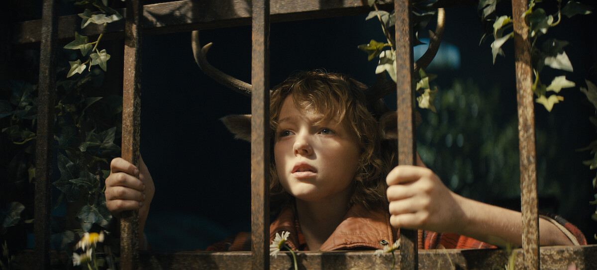 Christian Convery stands behind bars as Gus 
