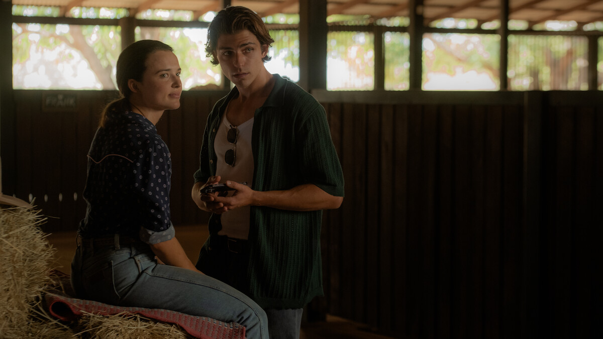 Philippa Northeast as Susie Lawson sits on a bail of hay with Joe Klocek as Lachie Kirby in a barn in Season 1 of ‘Territory’