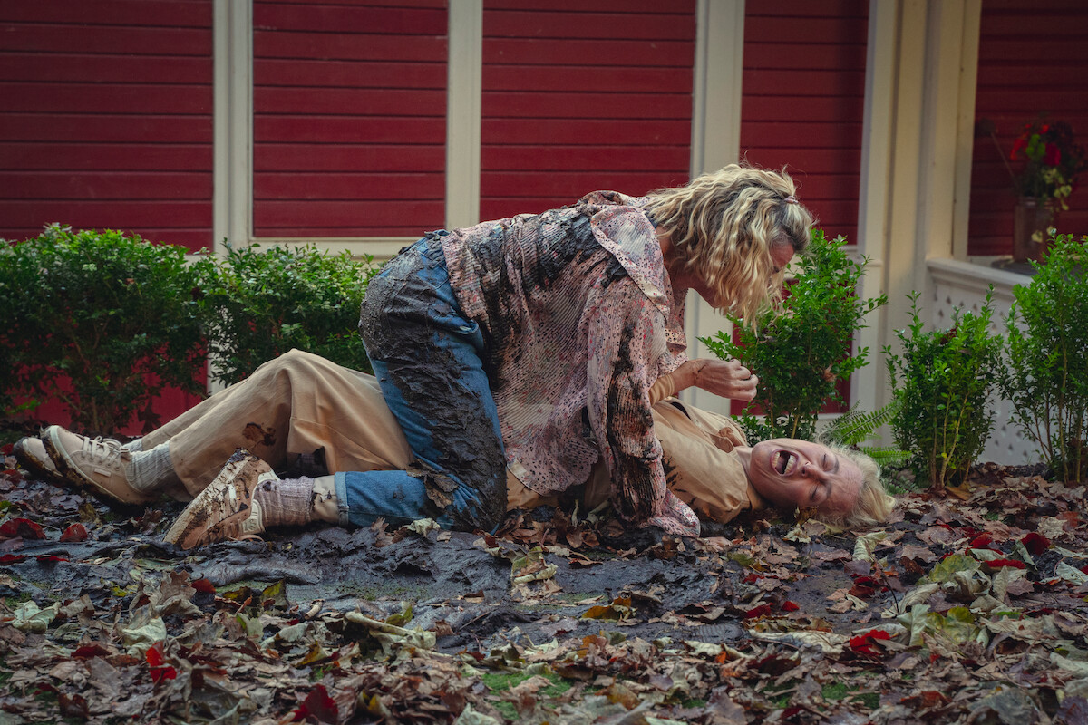 Lisa McGrillis as Joanna and Gillian Anderson as Jean wrestle each other in Season 4 of ‘Sex Education.’