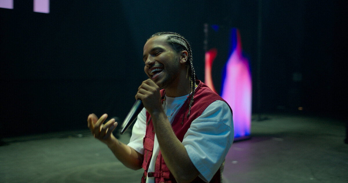 Tyler Dean Flores as Santi sings on stage in Season 1 of 'Neon'.