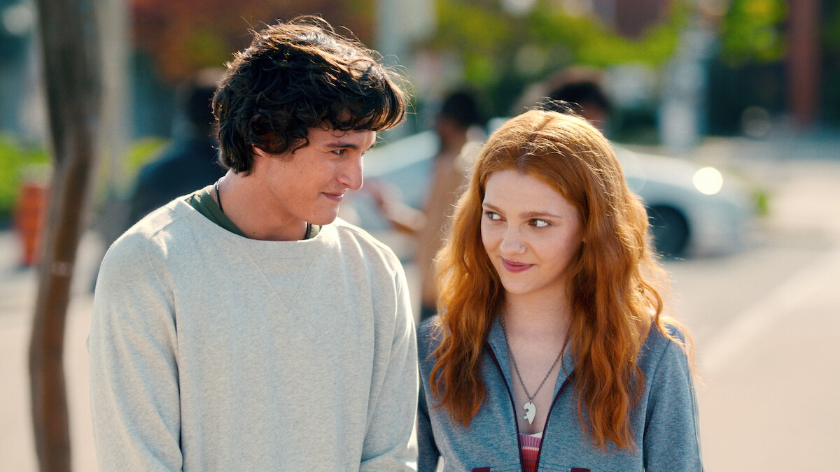 Liam Woodrum as Nick Park and Emily Carey as Harriet Manners walk side by side down the street in an image from the series 'Geek Girl.'