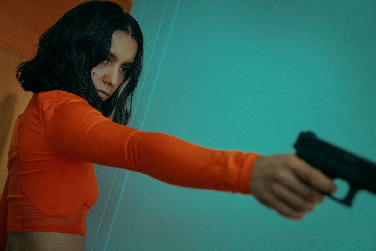 Lina El Arabi as Lyna Guerrab points a gun in a still image from Season 1 of ‘Furies.’