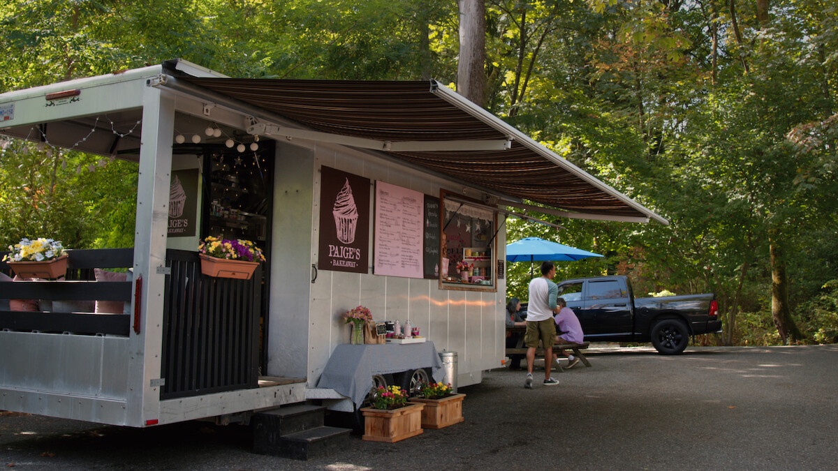 Paige’s Bakeaway bakery truck parked in lot surrounded by trees in ‘Virgin River’
