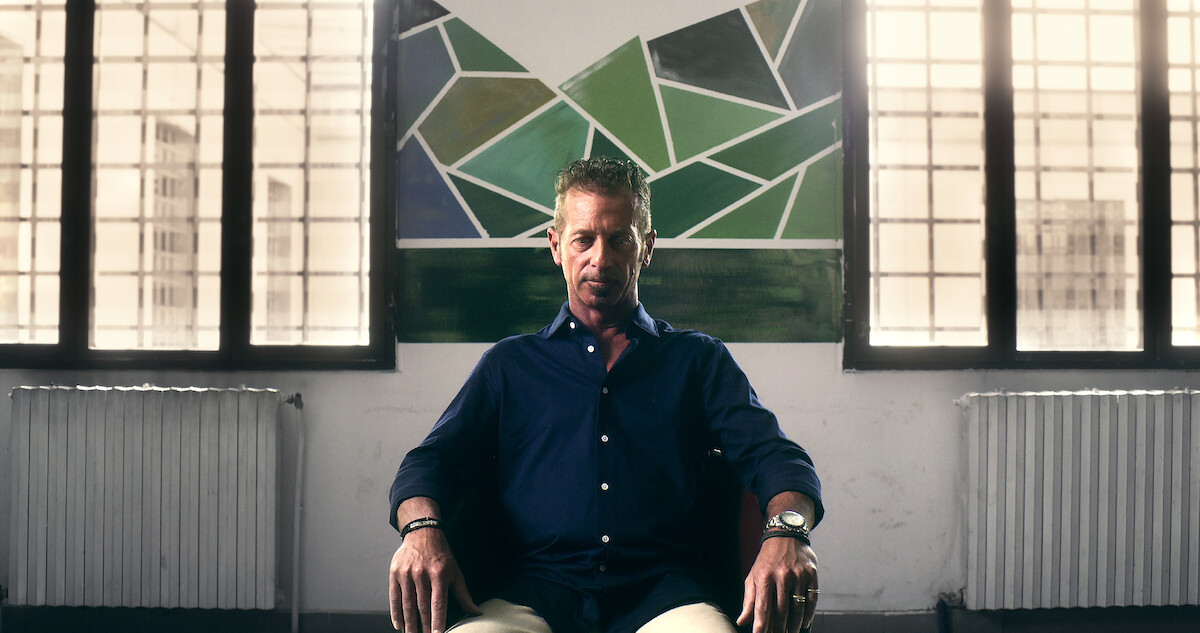 A man sits on a chair with a defeated expression in 'The Yara Gambirasio Case: Beyond Reasonable Doubt'