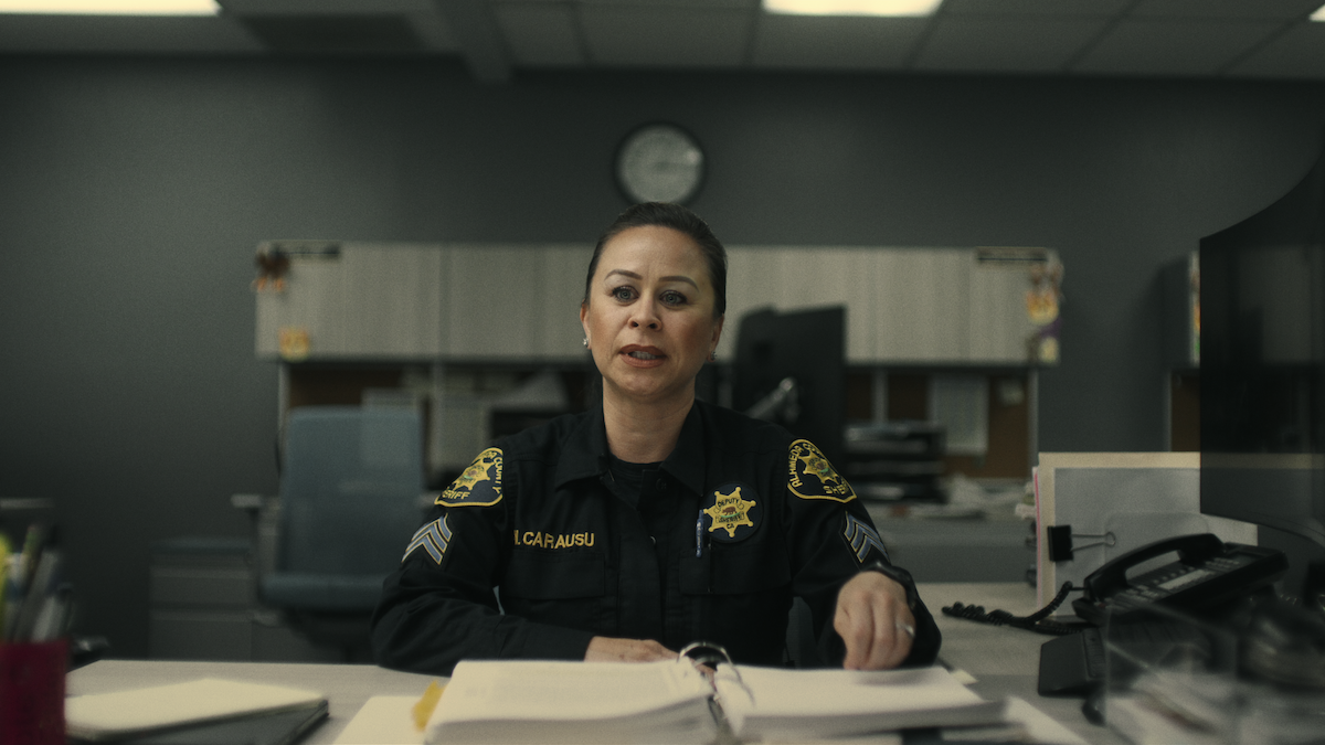 Misty Carausu sits at her desk.