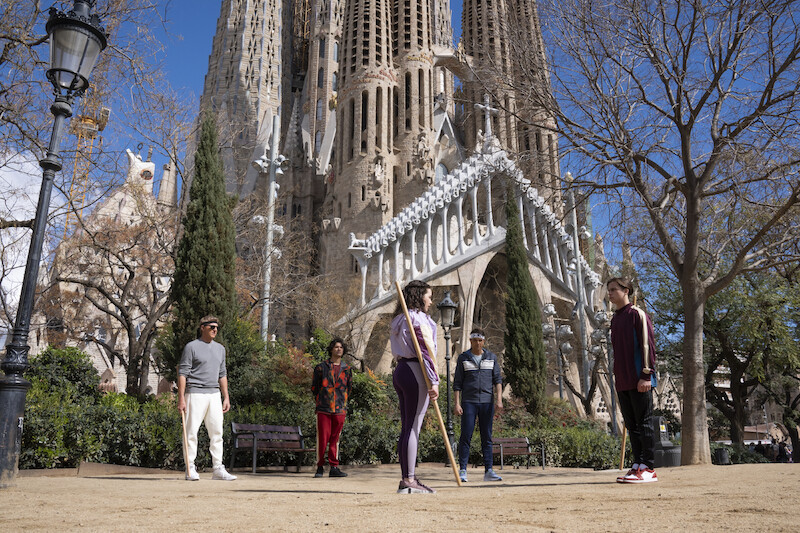 William Zabka as Johnny Lawrence, Xolo Maridueña as Miguel Diaz, Mary Mouser as Samantha LaRusso, Ralph Macchio as Daniel LaRusso, and Tanner Buchanan as Robby Keene train in font of a cathedral in Season 6, Part 2 of 'Cobra Kai'