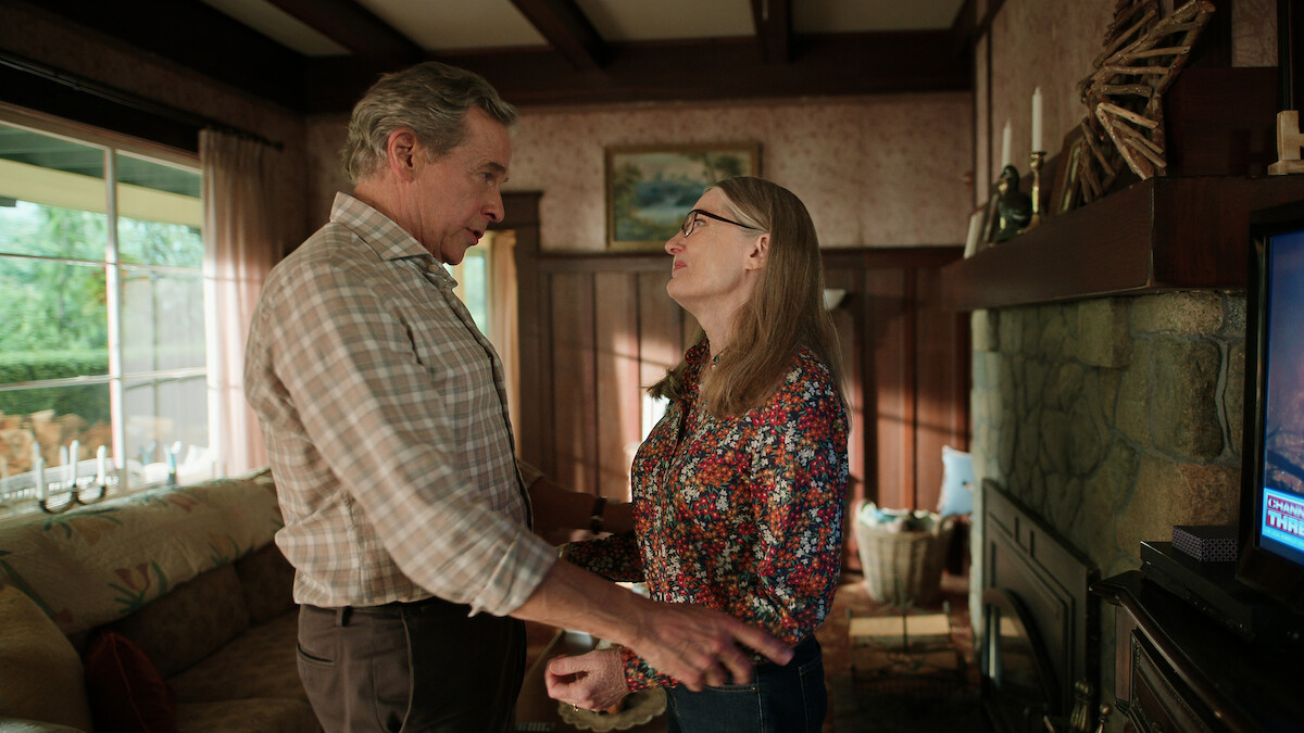 Tim Matheson as Doc Mullins and Annette O’Toole as Hope stand facing each other lovingly at home in Season 5 of ‘Virgin River.’